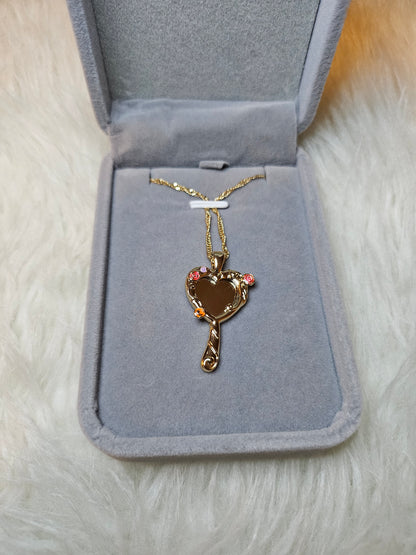 Mirror of Venus Necklace displayed in a grey jewelry box with elegant heart-shaped design.
